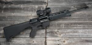 An AR-15 first rifle displayed on a wood background